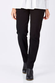 Model Yasmin wearing size 10 of the Slim Miracle Denim Jeans in colour Black (Black), from the front, cropped image