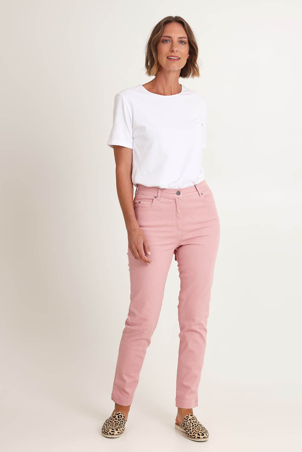 Model Riina wearing size 10 of the Slim Miracle Denim Jeans in colour Blush (Pink), from the front, showing the whole outfit