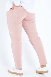 Model Sasha-Lee wearing size 16 of the Slim Miracle Denim Jeans in colour Muskpink (Pink), from the back