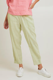 Model Grace wearing size 10 of the Pull On Linen Pant in colour Celery (Green), from the front, cropped image