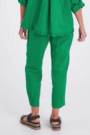 Model Emma wearing size 10 of the Pull On Linen Pant in colour Emerald (Green), from the back