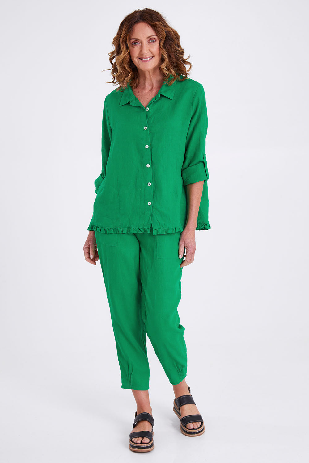 Model Emma wearing size 10 of the Pull On Linen Pant in colour Emerald (Green), from the front, showing the whole outfit