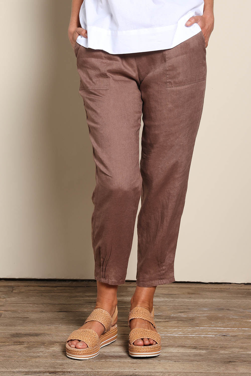 Model Riinar wearing size 10 of the Pull On Linen Pant - Mocha in colour Mocha, in a cropped view