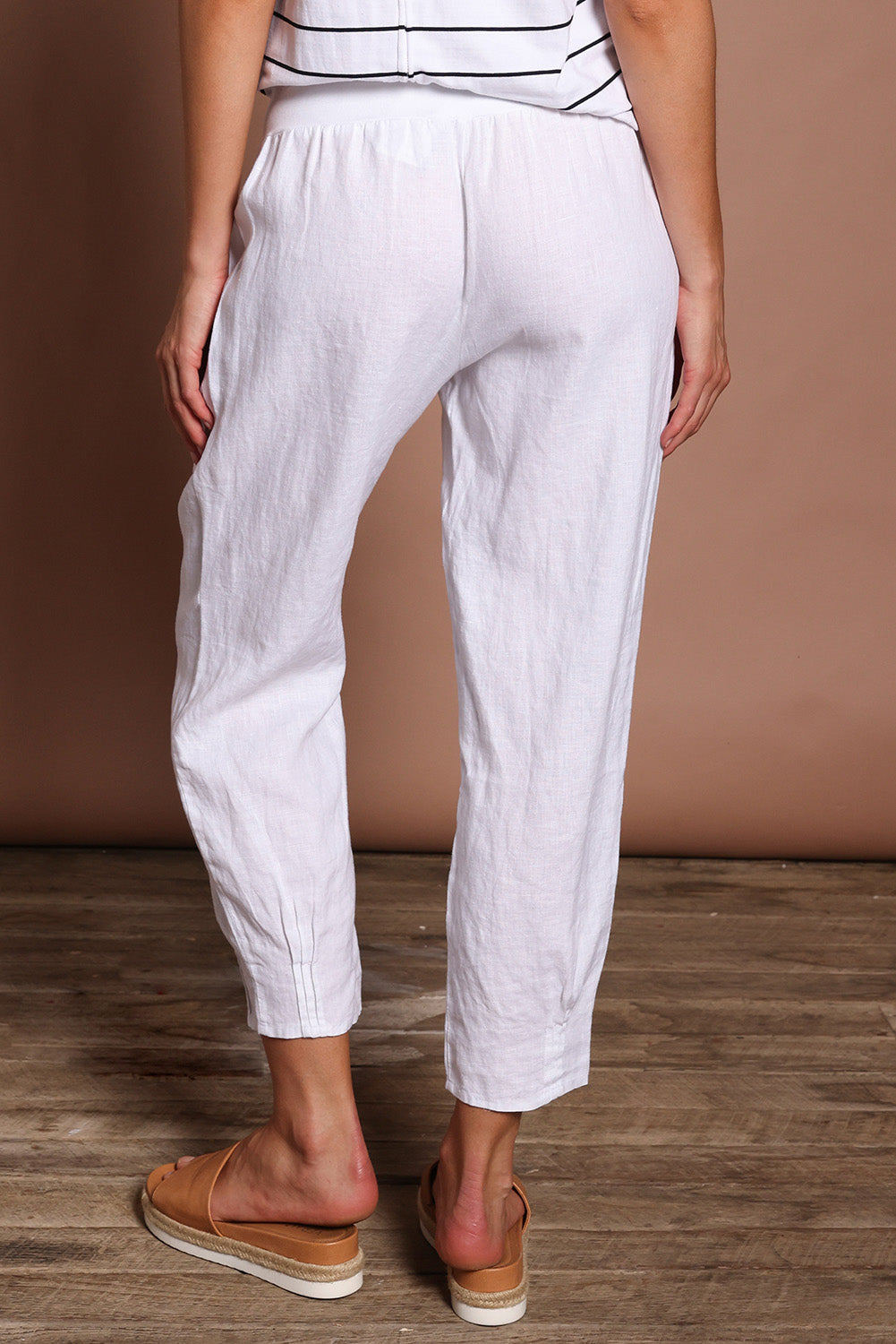 Model Madeline wearing size 10 of the Pull On Linen Pant in colour White (White), from the back