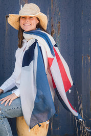 A model wearing the Alice Abstract Geo Scarf in colour Navywhtred (Blue), from the front, showing the whole outfit