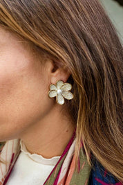 Model Genericm wearing size sample of the Bronte Flower Stud Earring - White in colour White, from an angle