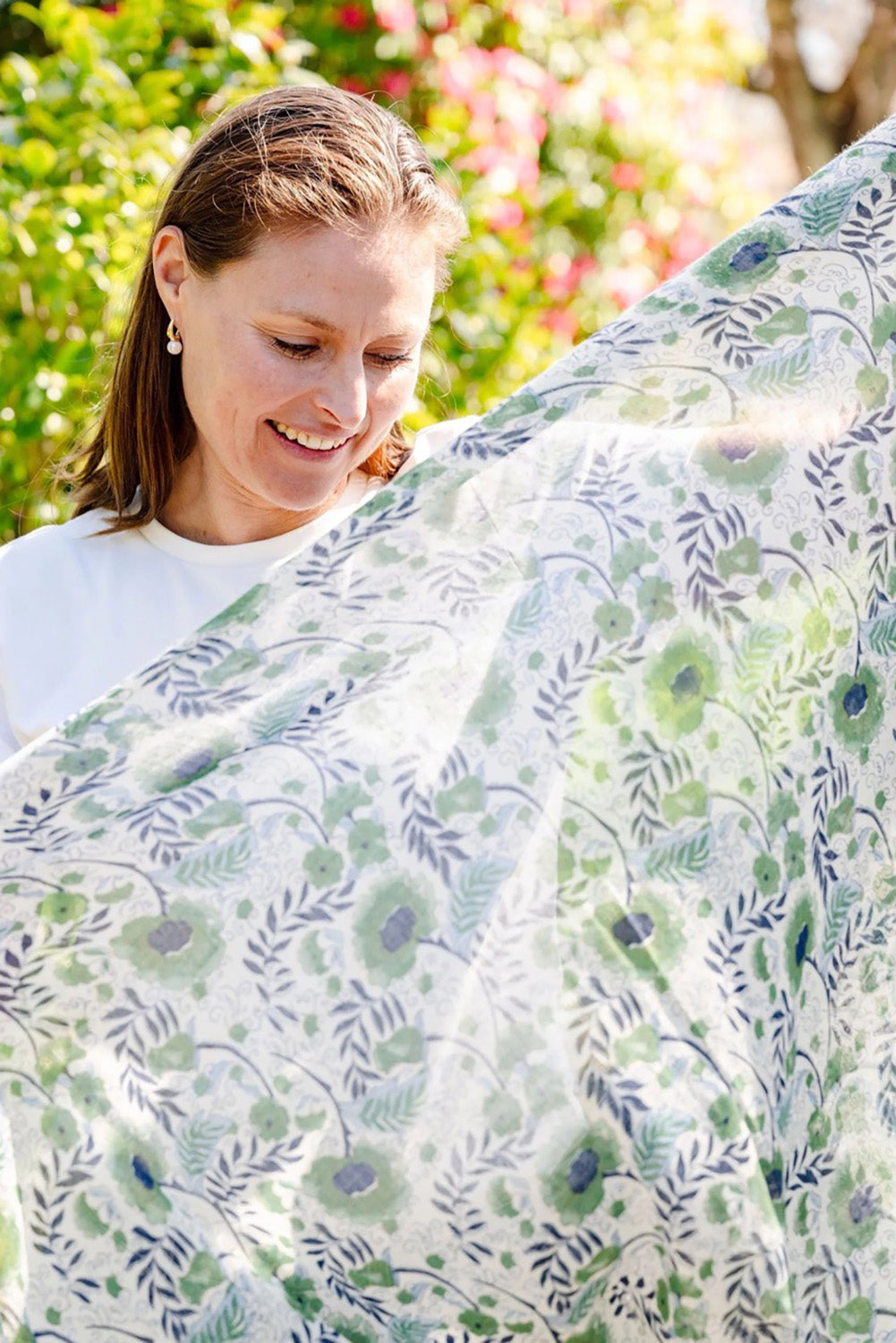 A model wearing the Caroline Floral Lightweight Scarf in colour Navykhaki, from the front, showing the whole outfit