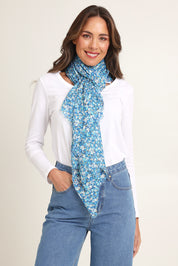 Model Madeline wearing the Cass Daisy Lightweight Scarf in colour Bluedaisy (Blue), from the front, showing the whole outfit