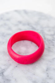 A model wearing the Resin Stacking Cuff Bangle in colour Hotpink (Pink), from the front, showing the whole outfit