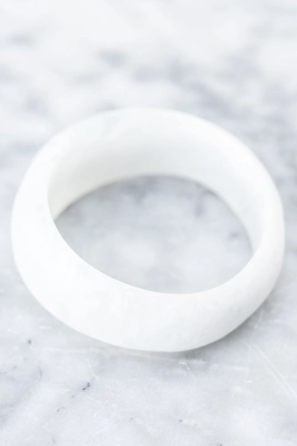 A model wearing the Resin Stacking Cuff Bangle in colour White (White), from the front, showing the whole outfit