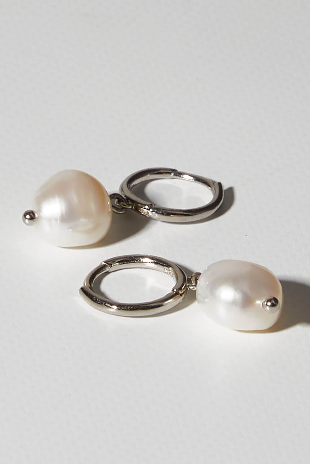 A model wearing size OneSize of the Freshwater Drop Pearl Earrings in colour Silver (Metallics), from the front, showing the whole outfit