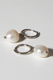 A model wearing size OneSize of the Freshwater Drop Pearl Earrings in colour Silver (Metallics), from the front, showing the whole outfit