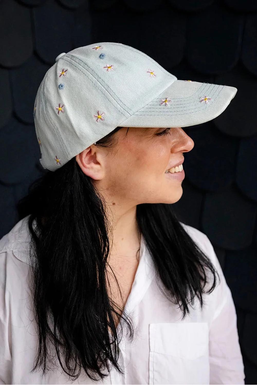 Model Genericm wearing size sample of the Embroidered Cap - Flowerlight in colour Flowerlight, from an angle
