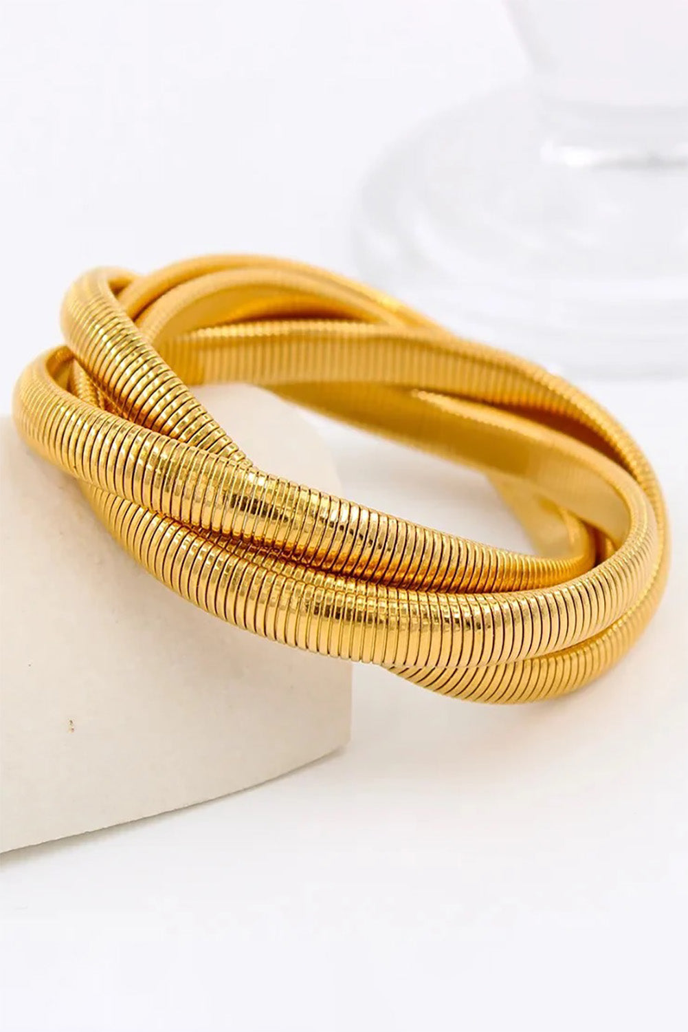 A model wearing the Flex Snake Chain Stretch Bracelet in colour Gold (Metallics), from the front, showing the whole outfit