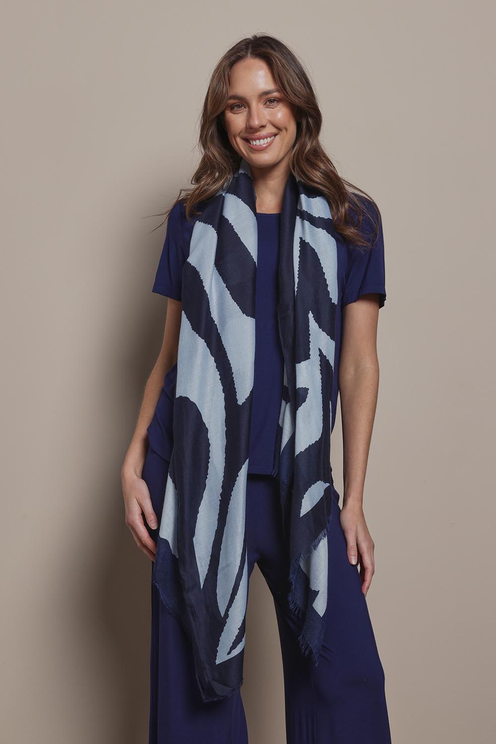 Model Madeline wearing the Isla Scarf in colour Navy (Blue), from the front, showing the whole outfit