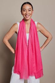 A model wearing the Solid Lightweight Scarf in colour Fuchsia (Pink), from the front, showing the whole outfit