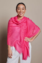 A model wearing the Solid Lightweight Scarf in colour Fuchsia (Pink), from the front, showing the whole outfit
