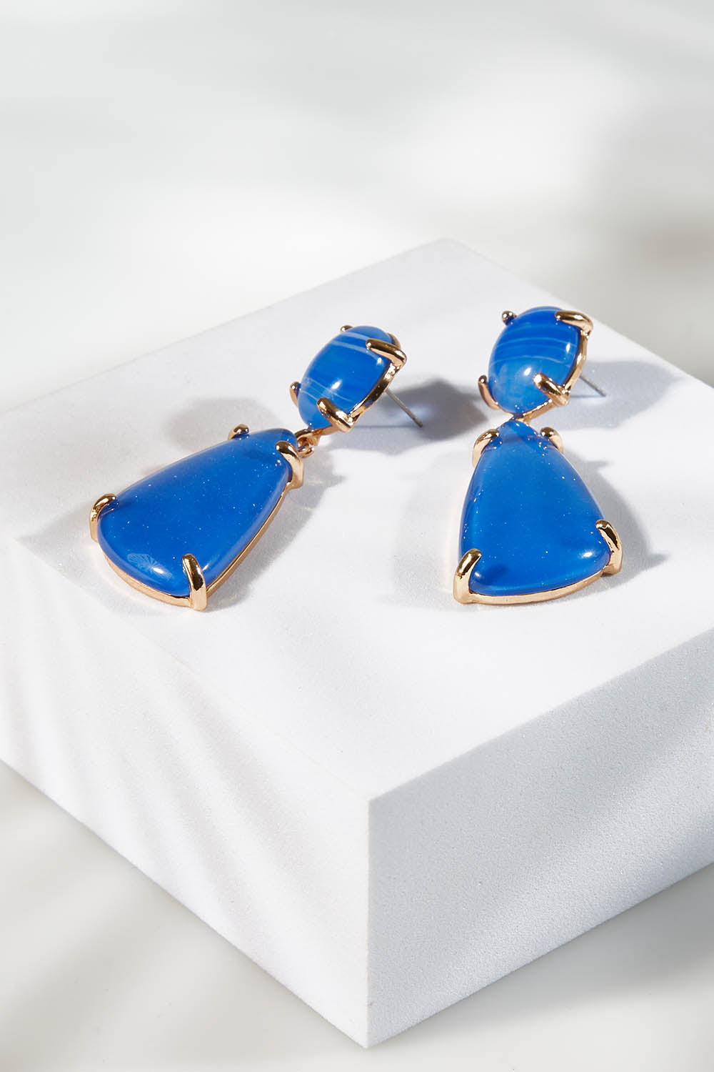 A model wearing size OneSize of the Resin Drop Earrings in colour Blue (Blue), from the front, showing the whole outfit