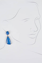 A model wearing size OneSize of the Resin Drop Earrings in colour Blue (Blue), from the front, showing the whole outfit