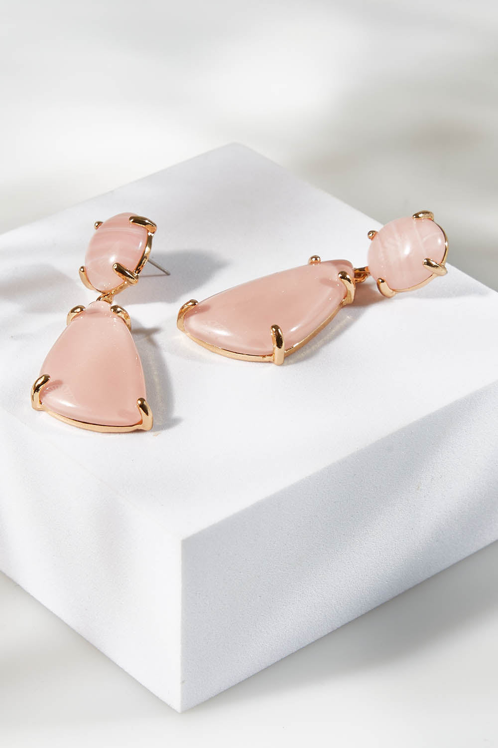 A model wearing size OneSize of the Resin Drop Earrings in colour Lightpink (Pink), from the front, showing the whole outfit