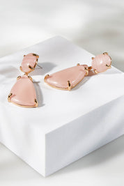 A model wearing size OneSize of the Resin Drop Earrings in colour Lightpink (Pink), from the front, showing the whole outfit