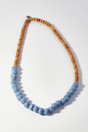 A model wearing size OneSize of the Mini Wood & Rock Necklace in colour Jacaranda (Blue), from the front, showing the whole outfit