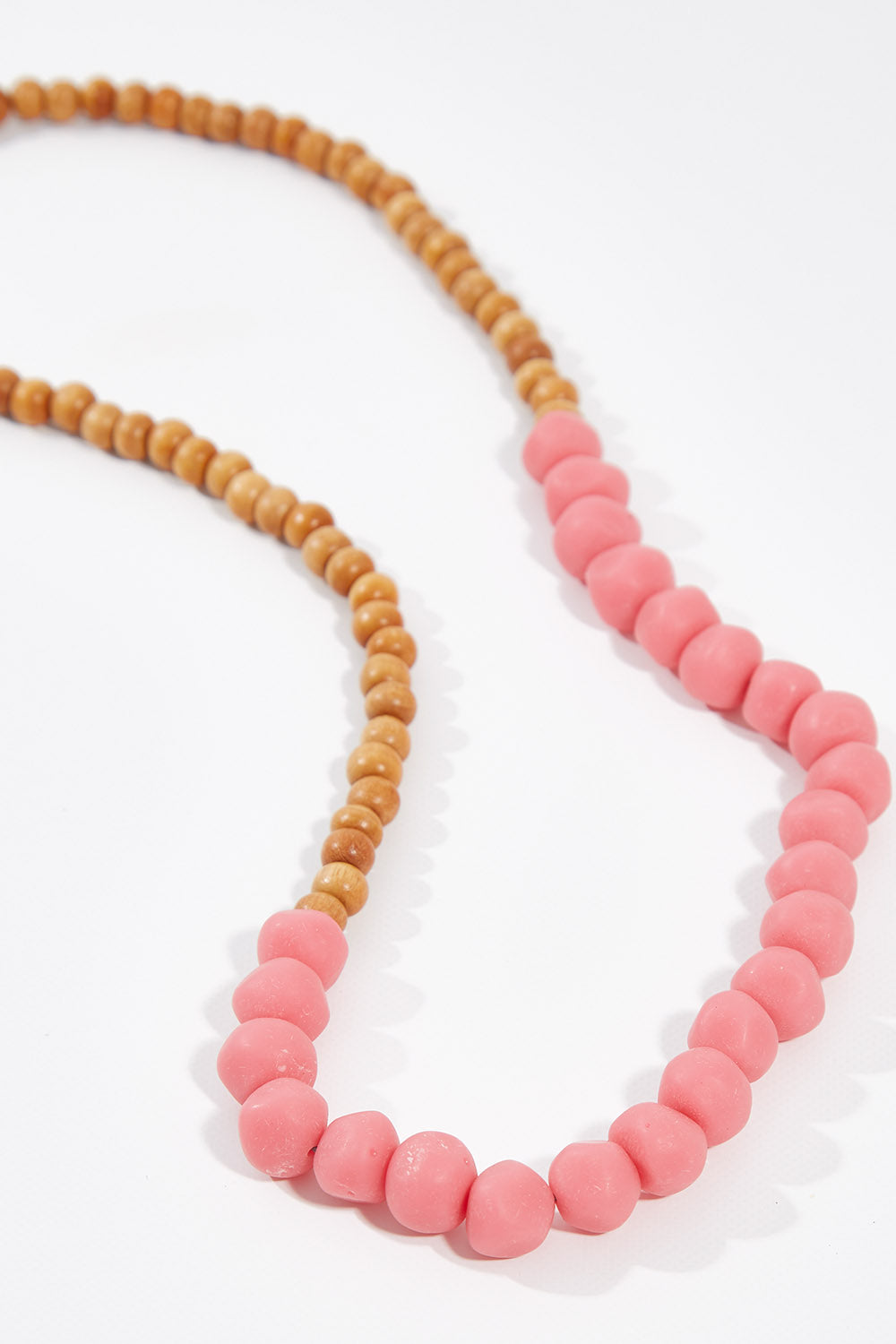 A model wearing size OneSize of the Mini Wood & Rock Necklace in colour Pink (Pink), from the front, showing the whole outfit