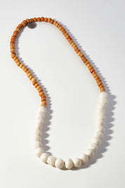 A model wearing size OneSize of the Mini Wood & Rock Necklace in colour White (White), from the front, showing the whole outfit