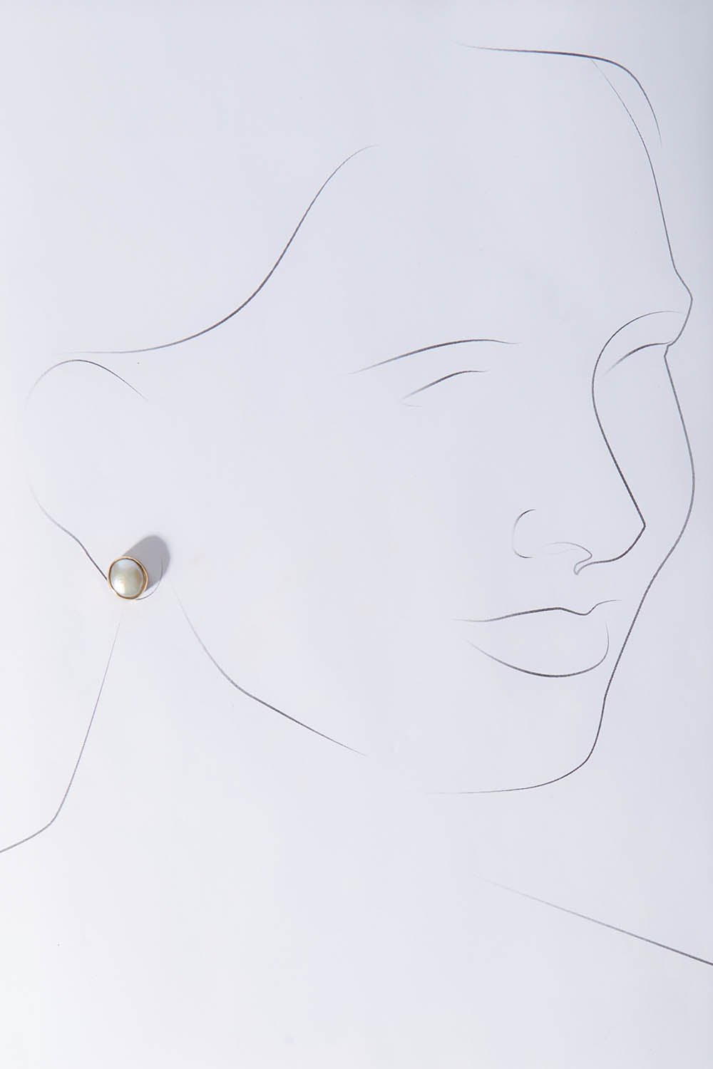 A model wearing size OneSize of the Bezel Set Pearl Stud in colour Gold (Metallics), from the front, showing the whole outfit