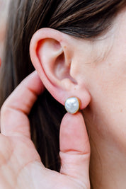 A model wearing the Bezel Set Pearl Stud in colour Gold (Metallics), from the front, showing the whole outfit