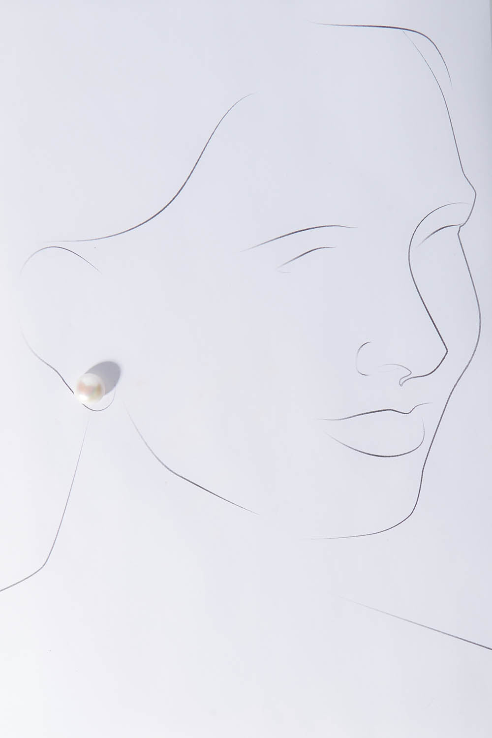 A model wearing size OneSize of the Sterling Silver Medium Pearl Stud in colour Silver (White), from the front, showing the whole outfit