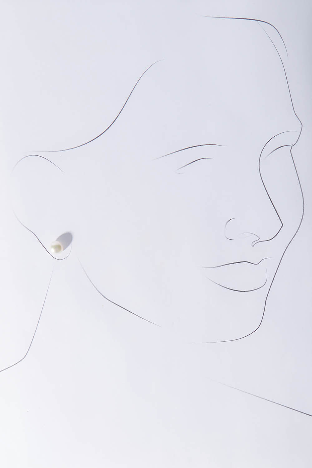 A model wearing size OneSize of the Sterling Silver Small Pearl Stud in colour Silver (White), from the front, showing the whole outfit