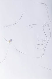 A model wearing size OneSize of the Sterling Silver Small Pearl Stud in colour Silver (White), from the front, showing the whole outfit