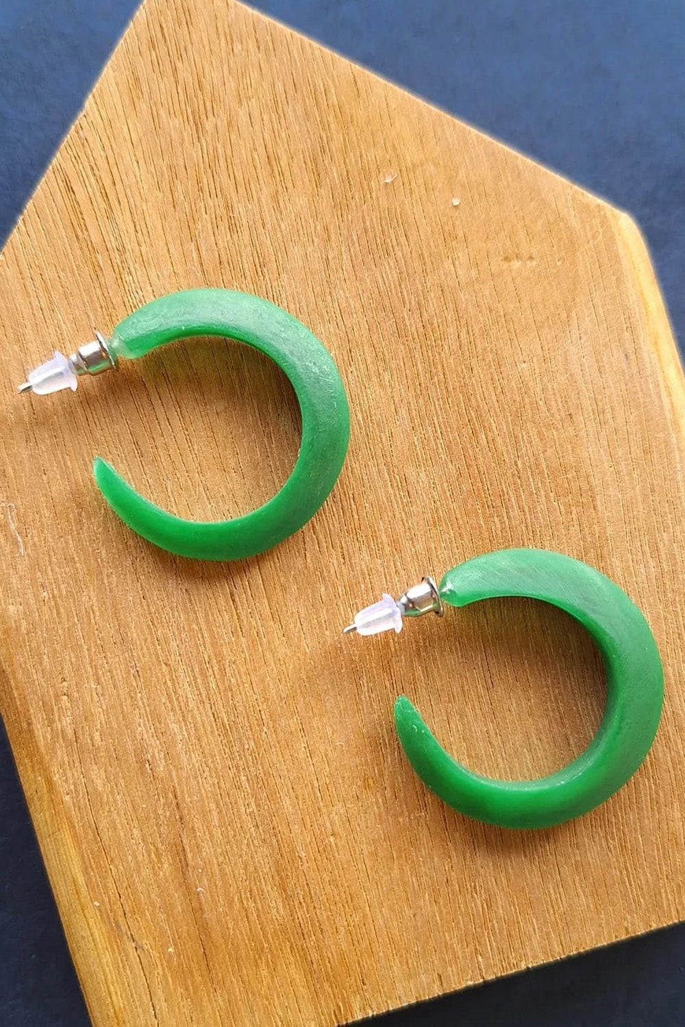 A model wearing the Point Finish Resin Hoop Earring in colour Green (Green), from the front, showing the whole outfit