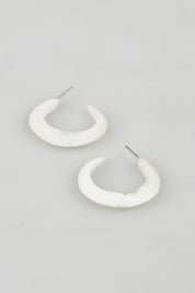 A model wearing the Point Finish Resin Hoop Earring in colour White (White), from the front, showing the whole outfit