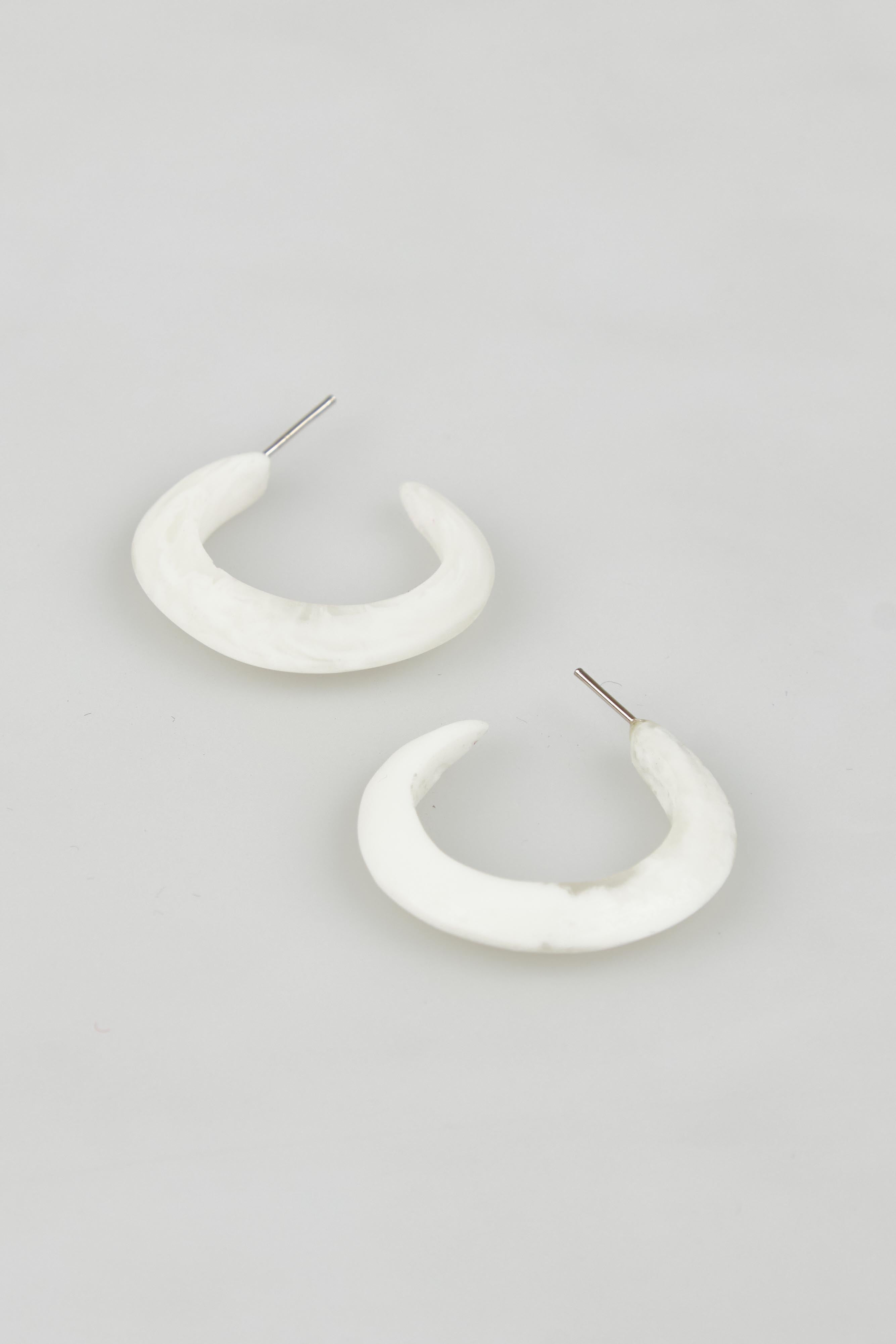 A model wearing the Point Finish Resin Hoop Earring in colour White (White), from the front, showing the whole outfit