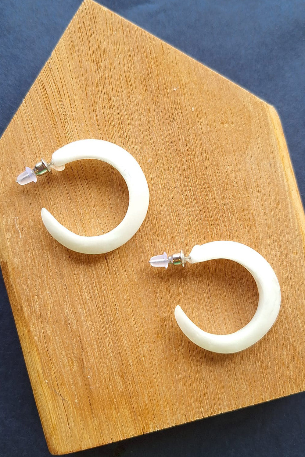 A model wearing the Point Finish Resin Hoop Earring in colour White (White), from the front, showing the whole outfit