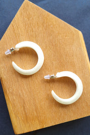 A model wearing the Point Finish Resin Hoop Earring in colour White (White), from the front, showing the whole outfit