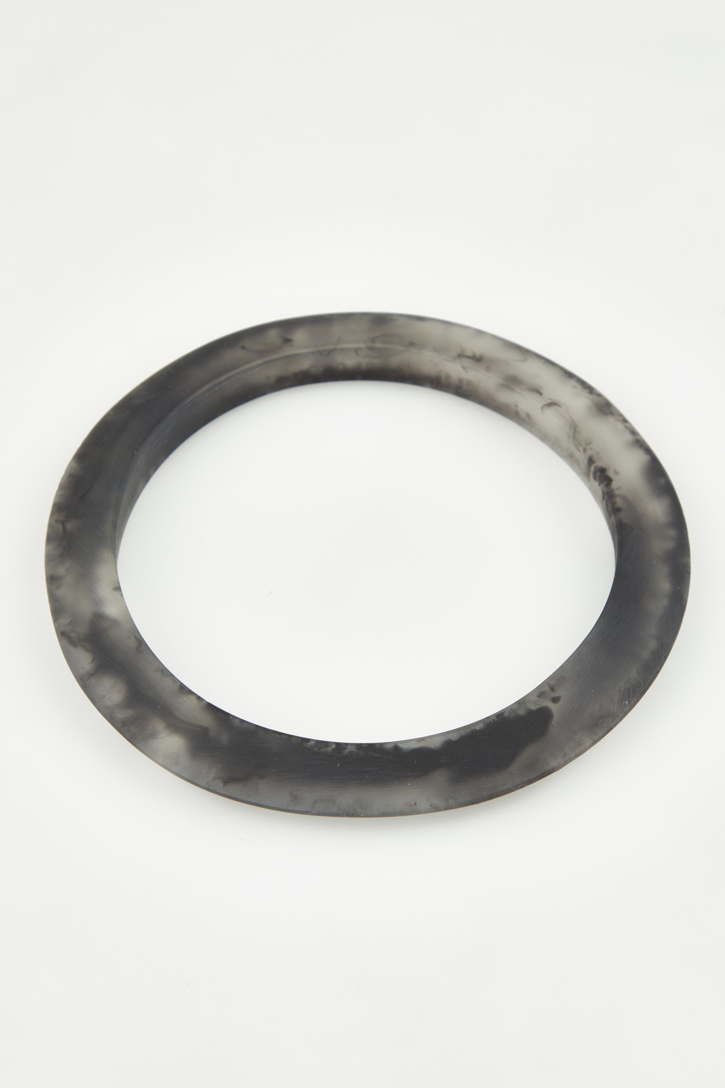 A model wearing the Point Resin Stacking Bangle in colour Black (Black), from the front, showing the whole outfit