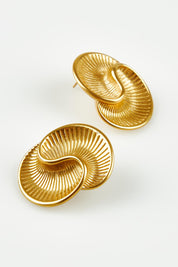 A model wearing the Prudence Sculptural Fan Earrings in colour Gold (Metallics), from the front, showing the whole outfit