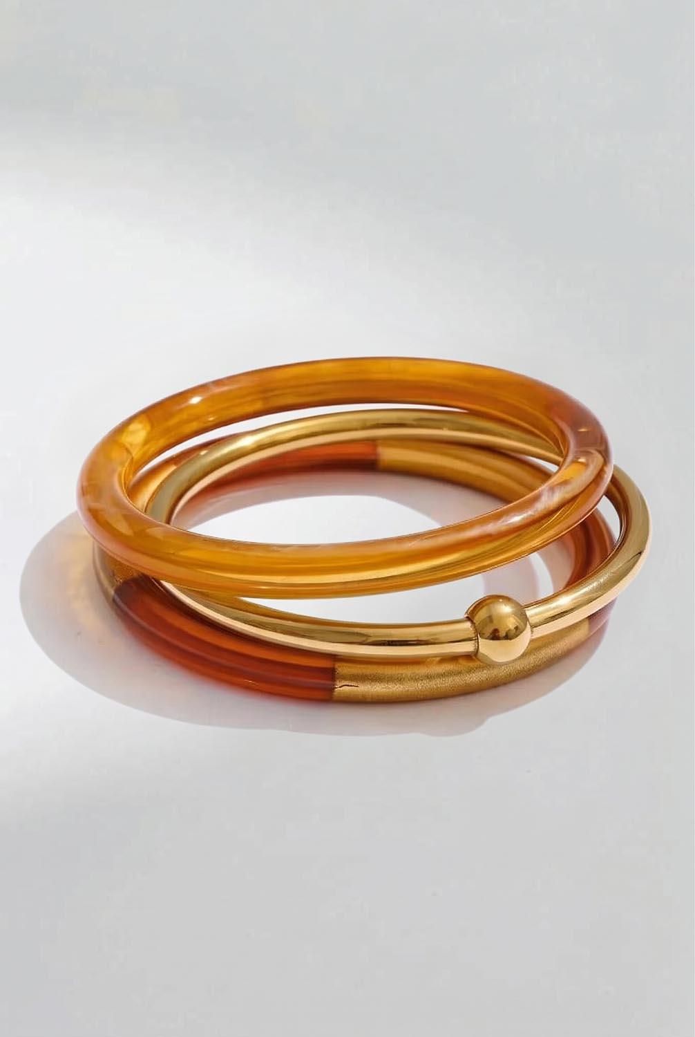 Product shot of the Riviera 3 Stack Bangle - Bronze in colour Bronze, from the front