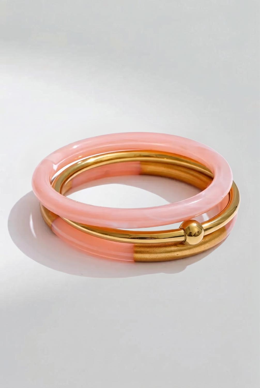 Product shot of the Riviera 3 Stack Bangle - Pink in colour Pink, from the front