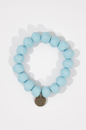 A model wearing size OneSize of the Rock Resin Bracelet in colour BabyBlue (Blue), from the front, showing the whole outfit