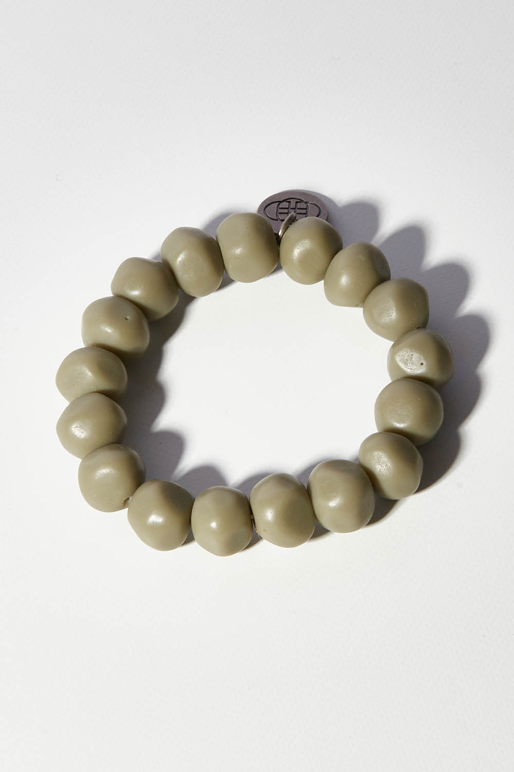 A model wearing size OneSize of the Rock Resin Bracelet in colour Moss (Green), from the front, showing the whole outfit