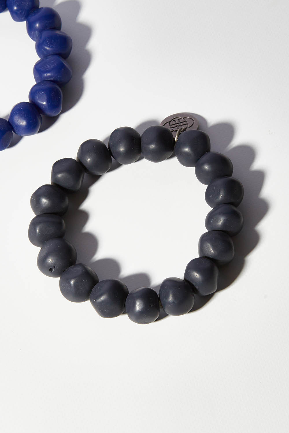 A model wearing size OneSize of the Rock Resin Bracelet in colour Navy (Blue), from the front, showing the whole outfit