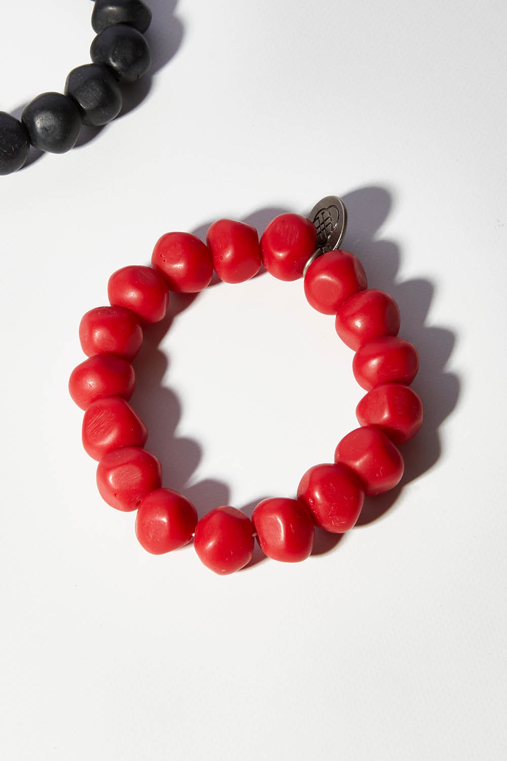 A model wearing size OneSize of the Rock Resin Bracelet in colour Red (Red), from the front, showing the whole outfit