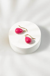 A model wearing size OneSize of the Enamel Drop Earrings in colour Hotpink (Pink), from the front, showing the whole outfit