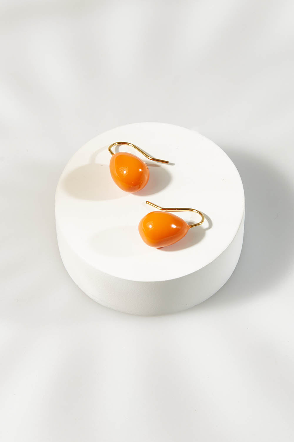 A model wearing size OneSize of the Enamel Drop Earrings in colour Orange, from the front, showing the whole outfit