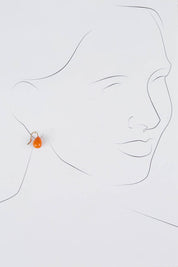 A model wearing size OneSize of the Enamel Drop Earrings in colour Orange, from the front, showing the whole outfit