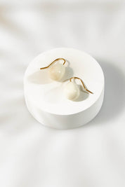 A model wearing size OneSize of the Enamel Drop Earrings in colour White (White), from the front, showing the whole outfit